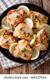 Italian Food: Chicken Piccata With Sauce, Lemon And Capers Close-up. Vertical View From Above
