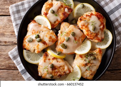 Italian Food: Chicken Piccata With Sauce, Lemon And Capers Close-up. Horizontal View From Above
