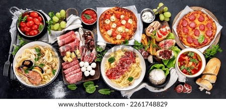 Italian food dishes on dark background. Traditional italian cuisine  concept. Dishes and appetizers of indeed cuisine. Mideterranean diet high in vitamin and antioxidants. Top view, panorama, banner