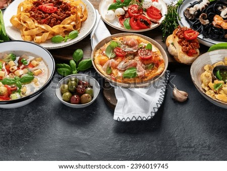 Italian food dishes on dark background. Traditional food concept. Copy space.