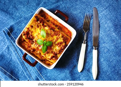 Italian Food. Hot Tasty Lasagna Plate Served With Fresh Basil Leaf. Top View, Selective Focus.