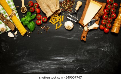 Italian Food Or Ingredients Background With Fresh Vegetables, Pasta, Cheese Parmesan And Spices. Top View, View From Above. Copy Space. 