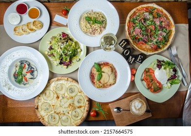 Italian Food Panorama. Pasta, Pizza, Ravioli, Lasagna And Salads Overhead Flat Lay Shot. Lots Of Dishes In The Italian Restaurant.