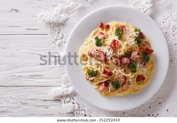 Italian food: pasta carbonara on the table.\
horizontal view from\
above