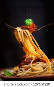 Italian Food. Pasta Spaghetti With Tomato Sauce, Olives And Garnish. Pasta Macro On Fork