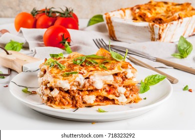 Italian Food Recipe. Dinner With Classic Lasagna Bolognese With Bechamel Sauce, Parmesan Cheese, Basil And Tomatoes, On White Marble Table, Copy Space