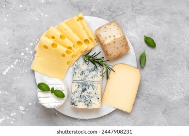 Italian and French gourmet cheese platter with craft cheese assortment on a marble platter. hard cheeses, mold cheese, gorgonzola, pecorino, Emmental, Roquefort - Powered by Shutterstock