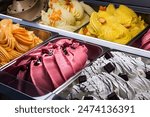 Italian gelato of various flavors in ice cream parlor