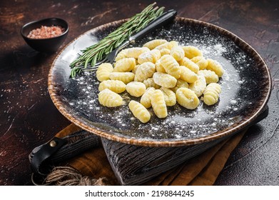 Italian Gnocchi Dumplings, Raw Potato Gnocchi On Plate With Thyme. Dark Background. Top View.