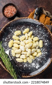 Italian Gnocchi Dumplings, Raw Potato Gnocchi On Plate With Thyme. Dark Background. Top View.