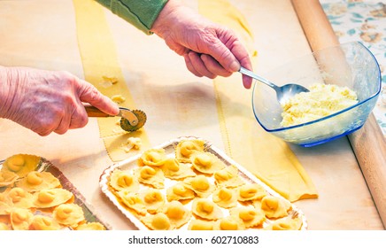 Italian Grandma Making Handmade Tortellini Pasta - Close Up Of Elderly Hands Working Traditional Food At Home - Concept Of Old Cooking Art With Soft Vintage Filter