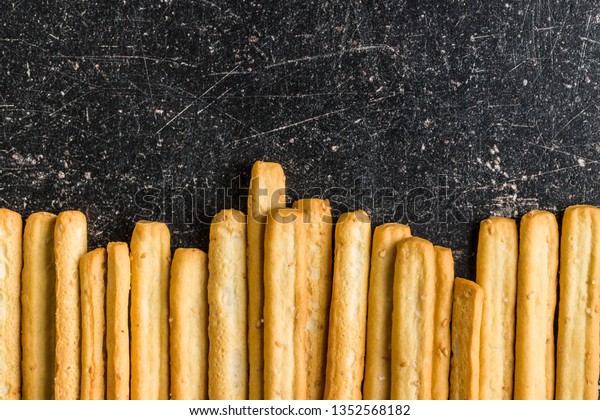 Italian grissini breadsticks. Tasty grissini
snack on old kitchen table. Top
view.