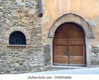 Italian House. Fragment Of Facade. Arches. Wooden Door. Stone Wall, Medieval Building. Photo Made In Toscana. Date Of Photo Is 28.09.2015