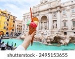 Italian ice cream gelato in front of amazing Trevi Fountain in Rome, Italy. Trevi Fountain or Fontana di Trevi. 