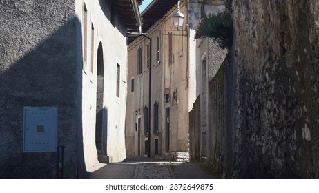 Italian Landscape: Alpine village. Hidden small treasure in Bergamo province alpine area. Val Taleggio rural hamlet. Church, Tower bell, rural narrow streets, landscape. Summer end