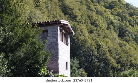 Italian Landscape: Alpine village. Small treasure in Bergamo province alpine area. Val Brembilla rural hamlet. Church, Tower bell, rural narrow streets, natural landscapes, scenarios. Autumn season