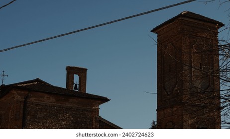 Italian Landscape: A glimpse into late sixteenth-century elegance in the Muratella Borgo. Medieval village in the Cologno al Serio municipality. (Bergamo province). Immaculate church and bell tower.