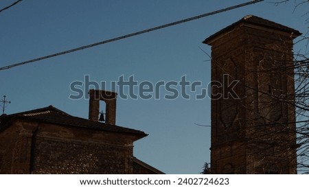 Italian Landscape: A glimpse into late sixteenth-century elegance in the Muratella Borgo. Medieval village in the Cologno al Serio municipality. (Bergamo province). Immaculate church and bell tower.