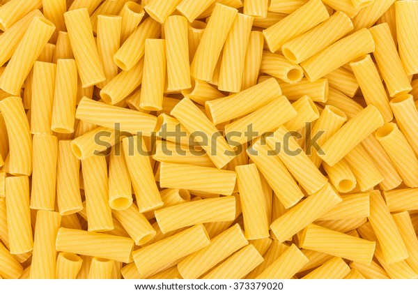 Italian Macaroni Pasta raw food yellow background and texture close up.