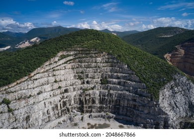 Italian marble quarries. Aerial view of an abandoned marble quarry. Top view of used mining in the alps. Panorama of developed mountain fossils.
