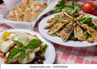 Italian meal includes grilled chicken, mozzarella salad, garlic rolls  - Powered by Shutterstock