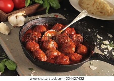 Similar – Image, Stock Photo Meatballs in tomato sauce on black tray. Above view of meat dish