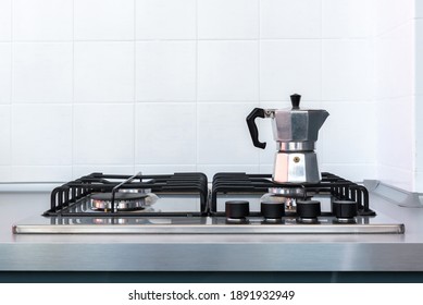 Italian Moka Coffee Pot Resting On Stove Top With Clean Aluminium Work Bench And White Tiles, Kitchen Setting