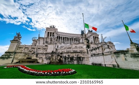 Italian national flag moving in wind with scenic view on front facade of Victor Emmanuel II monument on Piazza Venezia in Rome (Roma), Lazio, Italy, EU Europe. Cityscape of Altar of the Fatherland