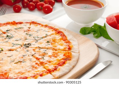 Italian Original Thin Crust Pizza Margherita With Gazpacho Soup And Watermelon On Side,and Vegetables On Background