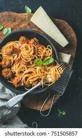 Italian Pasta Dinner. Spaghetti With Meatballas, Basil And Parmesan Cheese In Black Plate Over Dark Rustic Wood Background, Top View, Slow Food Concept