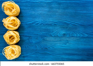 Italian Pasta Fettuccine Nest On Blue Wooden Table Top View Copyspace