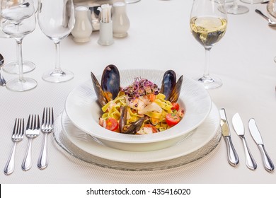 Italian Pasta With Seafood  On A Classy Restaurant Table