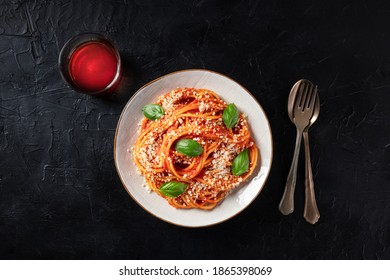 Italian Pasta. Spaghetti With Tomato Sauce, Grated Parmesan Cheese And Fresh Basil, Overhead Shot On A Dark Background