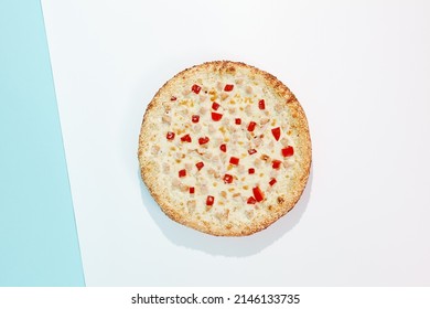 Italian pizza with chicken and paprika on coloured background. Cheese pizza with chicken and corn in minimal style on blue and purple color. American pizza delivery concept with color backdrop.