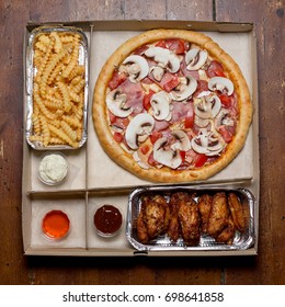 Italian Pizza In The In Delivery Box With Chicken Wings