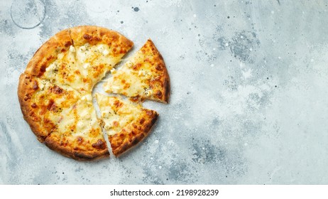 Italian pizza four cheeses with stretching cheese and basil on a light concrete background. - Powered by Shutterstock