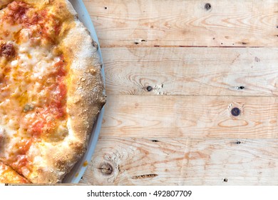 italian pizza served on wooden table.
