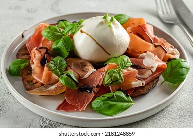 Italian Prosciutto With Burrata Cheese, Fresh Basil, Tomatoes, And Balsamic Vinegar. Shallow Depth Of Field. Mediterranean Food, Copy Space.