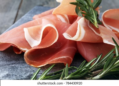 Italian prosciutto crudo or jamon with rosemary. Raw ham. - Powered by Shutterstock