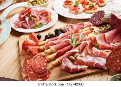 Italian Prosciutto, Cured Pork Meat On Cutting Board