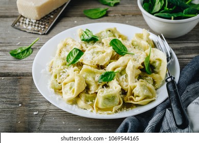 Italian ravioli pasta with spinach and ricotta on wooden rustic background