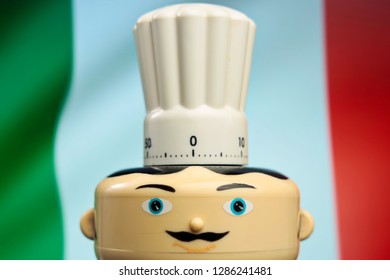 Italian restaurant symbol. Kitchen clock. Chef with torque and mustache with flag of Italy in background. Food delivery. Restaurant serving pizza and other menu specialties. Italian cooking - Image