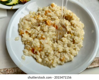 Italian Risotto Alla Parmigiana With Pumpkin And Almonds. High Quality Photo