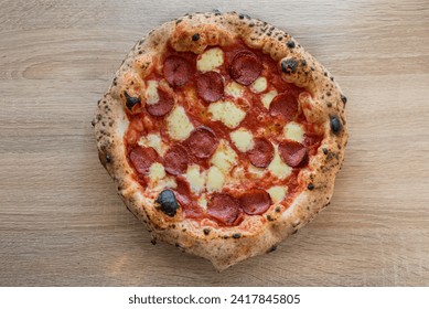 Italian salami pepperoni pizza, fermented, dough ,Neapolitan oven, close-up on wooden table background - Powered by Shutterstock