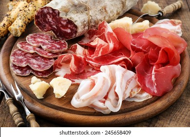 Italian salumi meat platter - prosciutto ham, bresaola, pancetta, salami and parmesan - Powered by Shutterstock