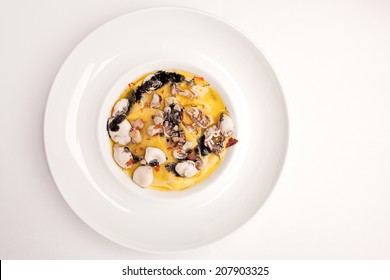 Italian sea food ravioli with squid ink. Fresh summer meal with octopus, squid, prawns. Delicious mediterranian finedinning dish. Cook at home