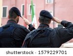 Italian soldiers saluting flag of Italy. Carabinieri saluting Italian flag. Italian Armed Forces