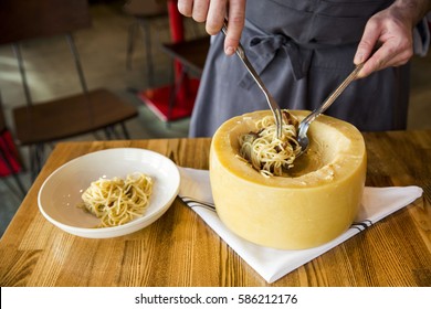 Italian Spaghetti Pasta Cooked Inside A Giant Parmesan Cheese Wheel