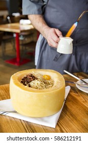 Italian Spaghetti Pasta Cooked Inside A Giant Parmesan Cheese Wheel