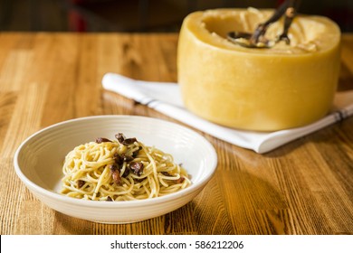 Italian Spaghetti Pasta Cooked Inside A Giant Parmesan Cheese Wheel